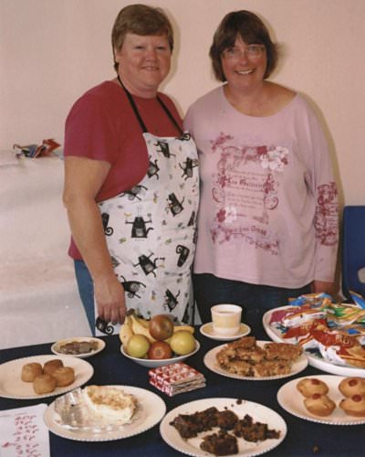 Rosemary and Cathy with their table of goodies