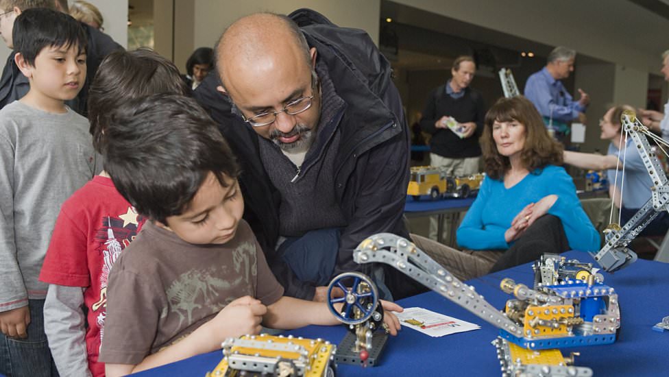 A family are fascinated by Chris Fry’s models (Photo: NMM)